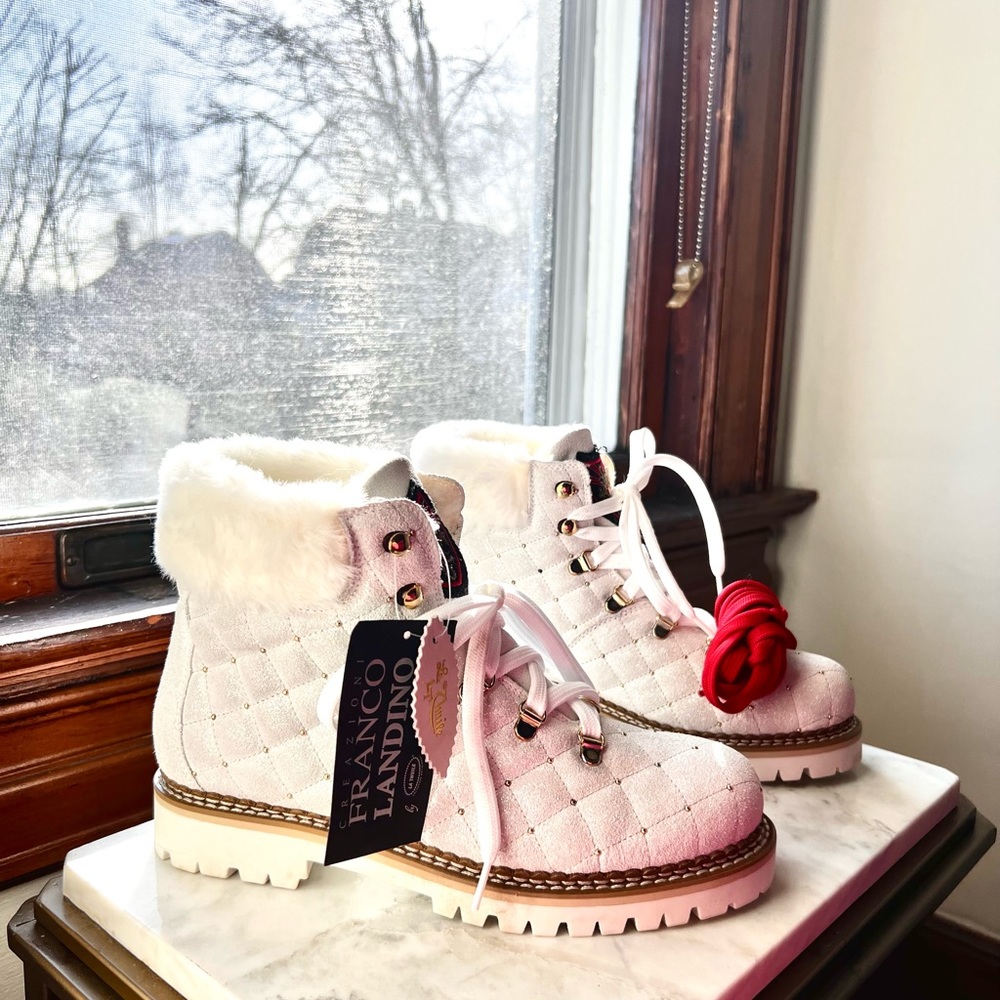 Brand new Thuile boots hand made leather with a side zip openingfaux fur cuff.